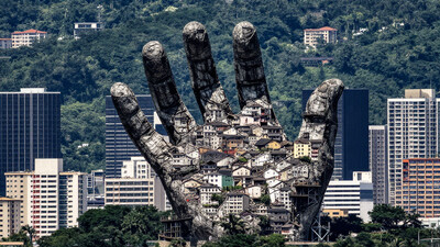 a city built on a (LAR-STAT hand) shaped rock with a distant lush landscape background