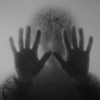 cinematic still A blurry black-and-white photo of two hands behind foggy glass, creating an eerie atmosphere. The background is a plain white wall, adding to the mysterious feel. A subtle hint of light can be seen through the misty haze around their palms, suggesting they may hold something dark or ominous. This scene creates an unsettling mood that leaves room for interpretation by viewers. The focus is on the hands, not the face. . . emotional, harmonious, vignette, highly detailed, high budget, bokeh, cinemascope, moody, epic, gorgeous, film grain, grainy