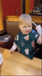 Baby With Spoon In Mouth