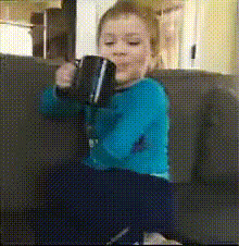Child On Couch With Cup
