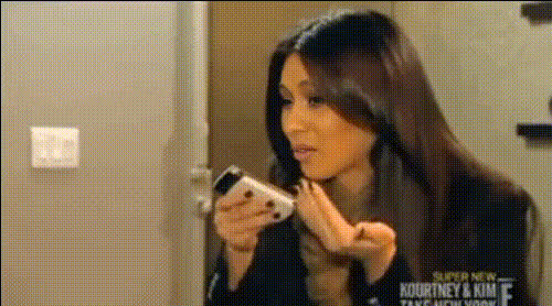 Kim Kardashian Smiling At Phone 1