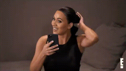 Kim Kardashian Smiling At Phone