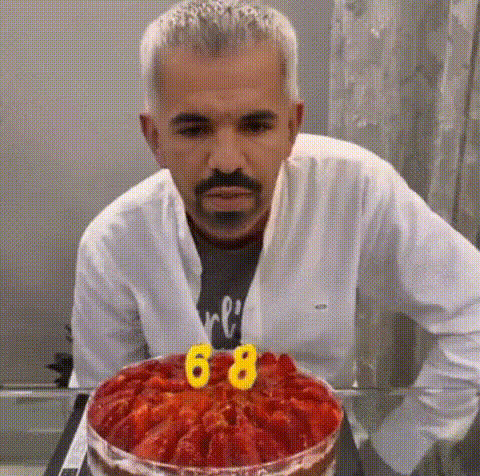 Man Blowing Out Candles