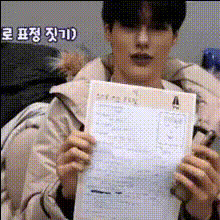 Man Holds Paper With Text
