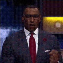 Man In Suit Waves On Stage