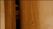 person-peeking-through-door