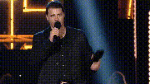 singer-holding-microphone-on-stage