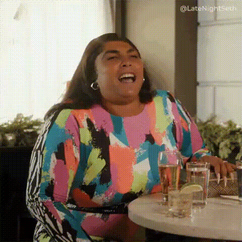 woman-laughing-at-a-table