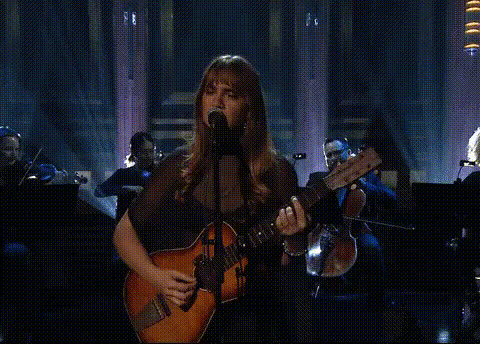 woman-singing-with-guitar